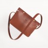 The shoulder strap triangle bag, brown leather